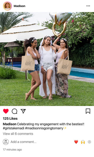 Three friends joyfully celebrating an engagement, each carrying a Maison Memoire custom tote bag.